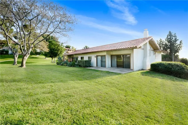 a view of a house with a backyard
