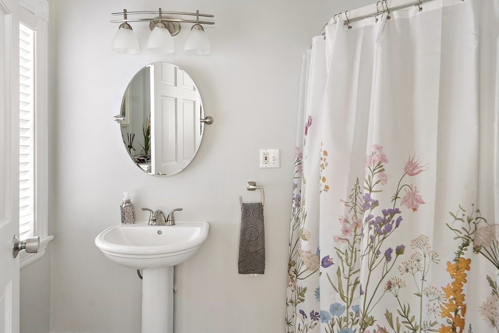 191 Centre Street Danvers, MA 01923 - Photo 26 of 40 a bathroom with a sink and mirror
