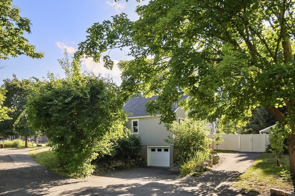 191 Centre Street Danvers, MA 01923 - Photo 36 of 40 a front view of a house with a yard and garage
