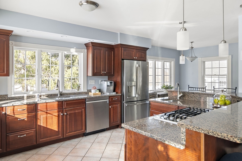191 Centre Street Danvers, MA 01923 - Photo 10 of 40 a kitchen with stainless steel appliances granite countertop sink stove and refrigerator