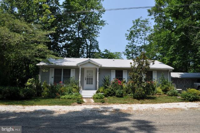 11538 Durango Road Lusby, MD 20657 - Photo 10 of 15 a front view of a house with a garden