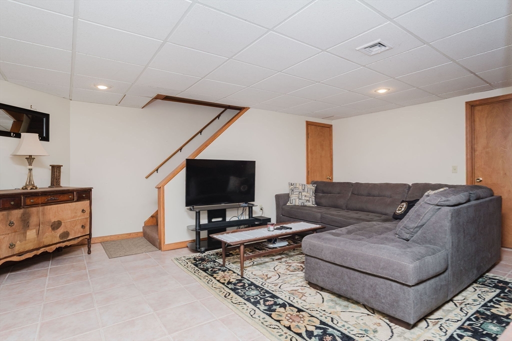 447 Stafford Road, Unit B1 Tiverton, RI 02878 - Photo 15 of 20 a living room with furniture and a flat screen tv