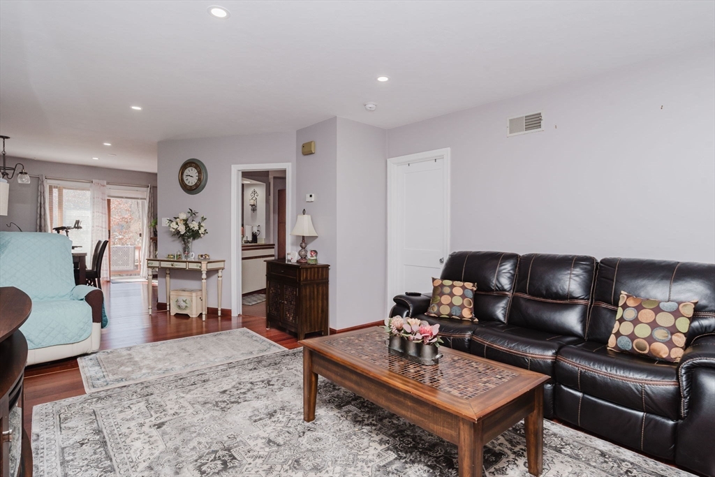 447 Stafford Road, Unit B1 Tiverton, RI 02878 - Photo 3 of 20 a living room with furniture rug and wooden floor