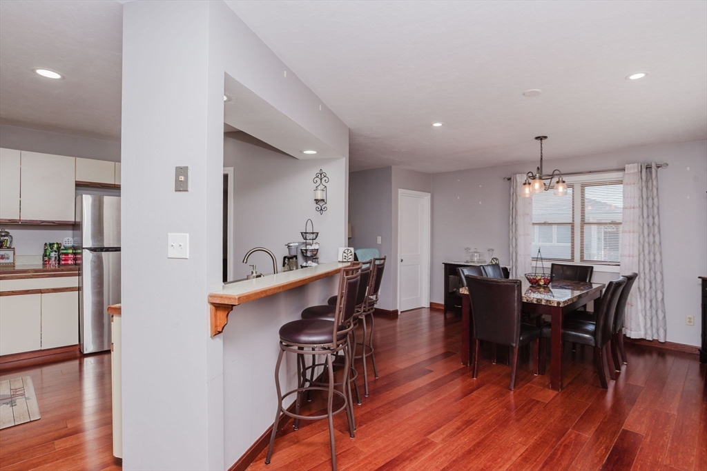 447 Stafford Road, Unit B1 Tiverton, RI 02878 - Photo 8 of 20 a view of a dining room with furniture and wooden floor