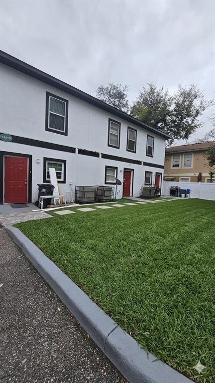 13612 North 21st Street Tampa, FL 33613 - Photo 2 of 4 a front view of a house with a yard and fence