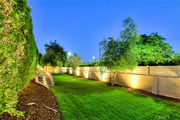 a kitchen with kitchen island granite countertop a sink stove and refrigerator