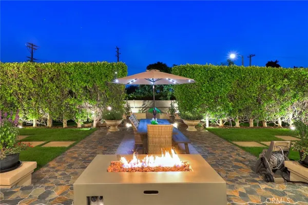 a kitchen with kitchen island granite countertop a sink and a refrigerator