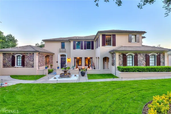 a front view of house with yard and green space