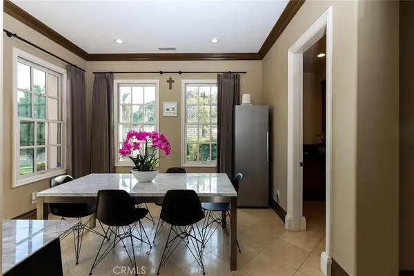 a dining room with furniture and a chandelier