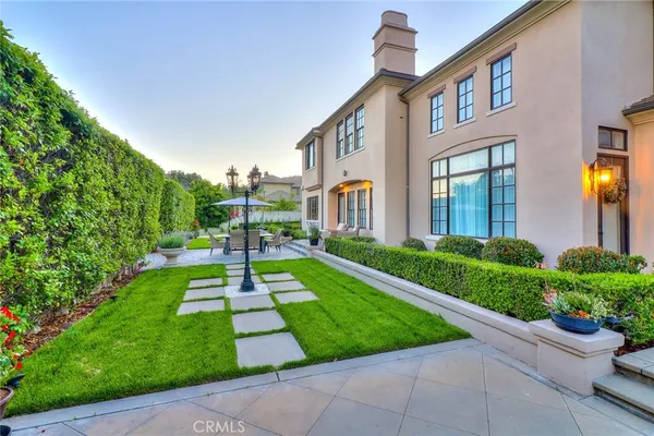 a view of a patio with a table and chairs under an umbrella