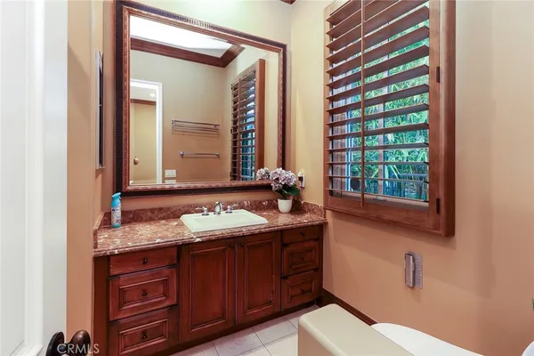 a bed sitting in a spacious bedroom next to a window