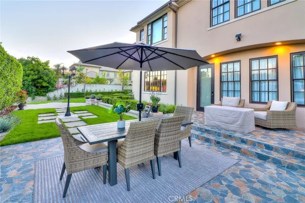 a front view of a house with garden and plants