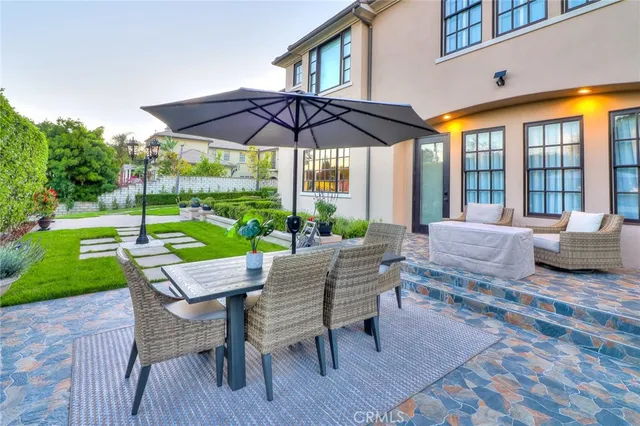 a front view of a house with garden and plants