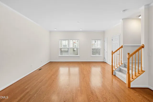 a living room with furniture a couch and two windows