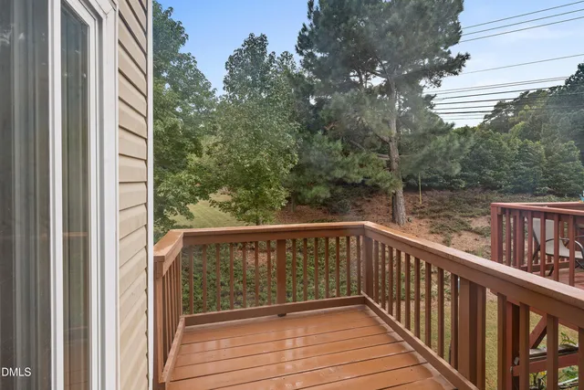 an empty room with windows and ceiling fan