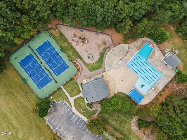 swimming pool view with a garden and seating area