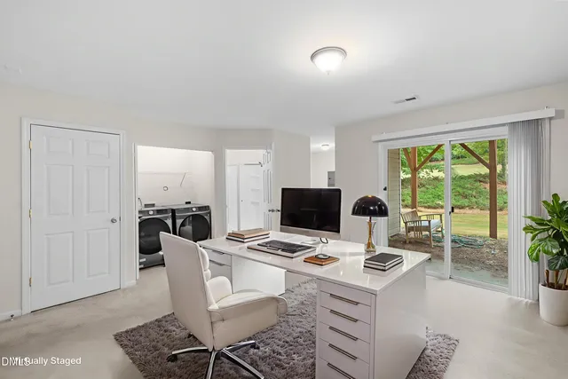 an entryway with a washer and dryer