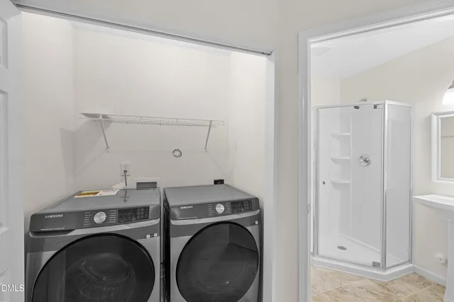 a bathroom with a shower sink vanity and toilet