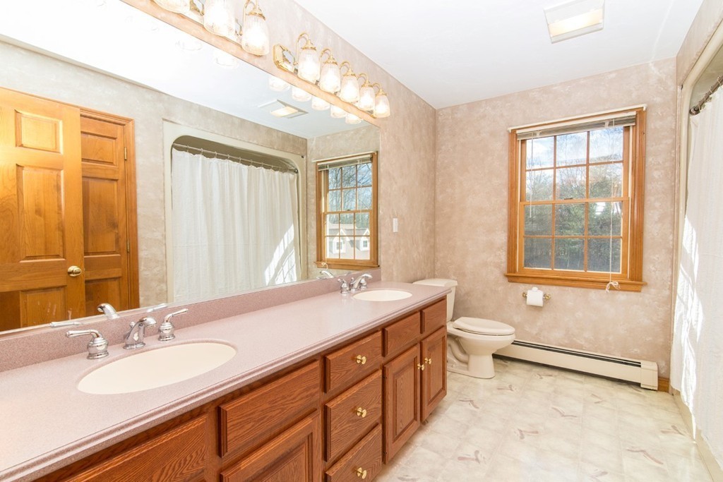 5 Parker Road Mendon, MA 01756 - Photo 14 of 28 a bathroom with a granite countertop double vanity sink a mirror and a bathtub