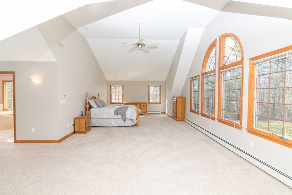 5 Parker Road Mendon, MA 01756 - Photo 15 of 28 a spacious bedroom with a large bed and a large window