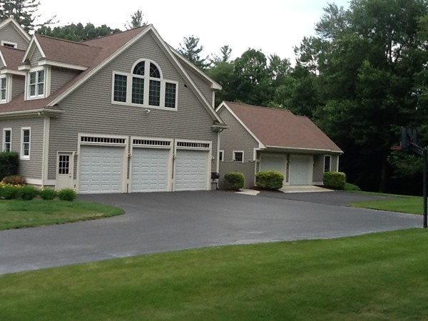 5 Parker Road Mendon, MA 01756 - Photo 3 of 28 a front view of a house with a yard and garage