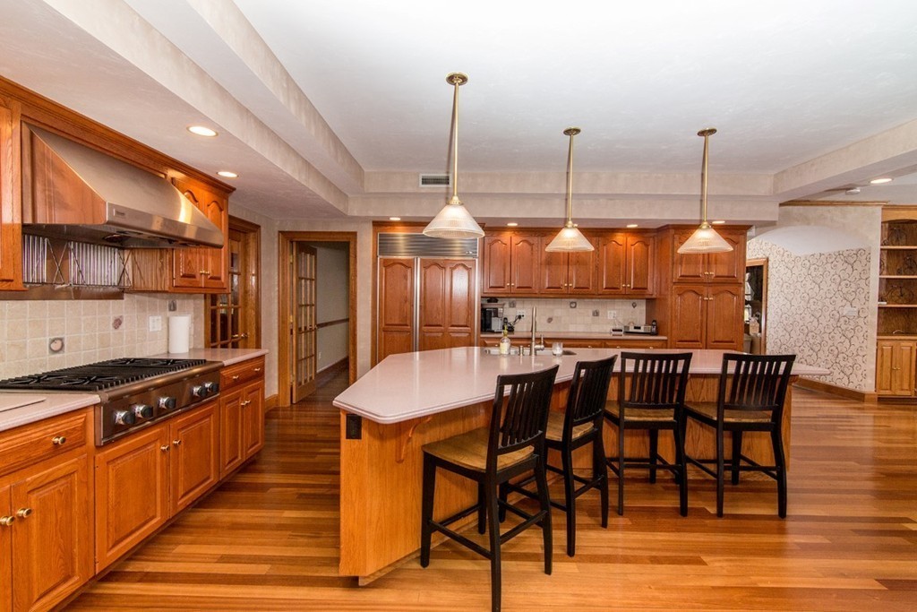 5 Parker Road Mendon, MA 01756 - Photo 4 of 28 a kitchen with stainless steel appliances kitchen island granite countertop a stove a sink and a dining table