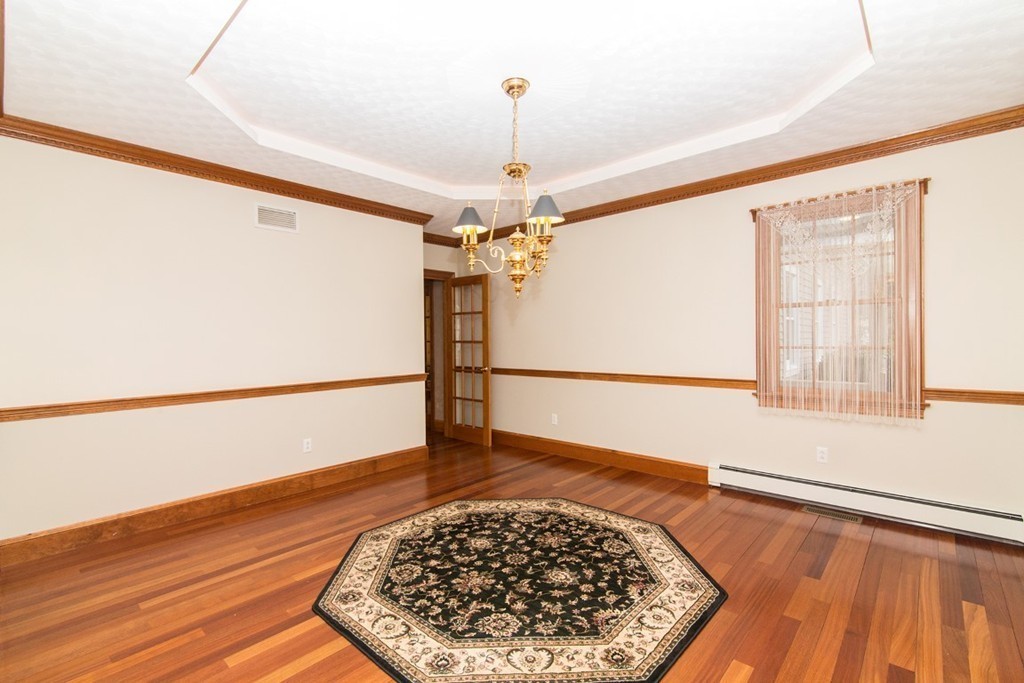 5 Parker Road Mendon, MA 01756 - Photo 9 of 28 a view of a hallway with wooden floor and chandelier