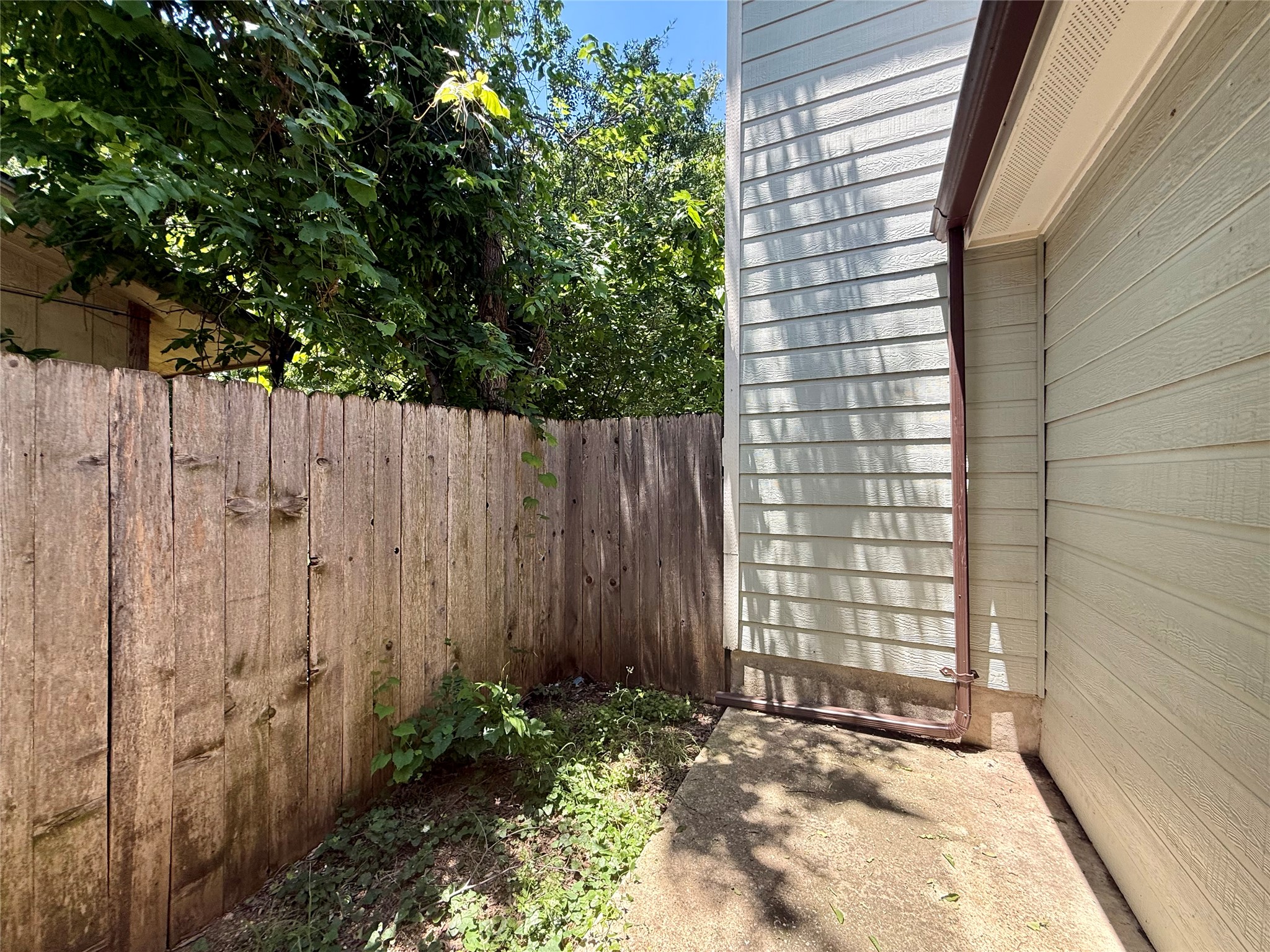 6912 Meador Avenue, Unit A Austin, TX 78752 - Photo 12 of 24 a view of a backyard with wooden fence