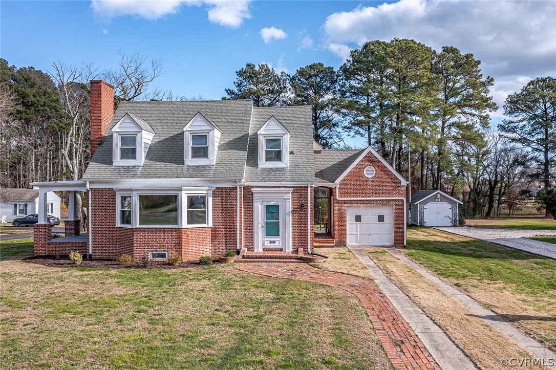 369 Main Street Reedville, VA 22539 - Photo 1 of 44 a front view of a house with a garden and pathway