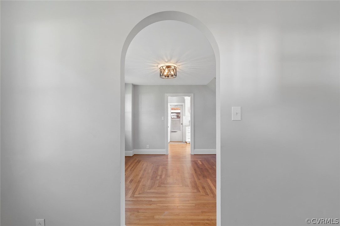 369 Main Street Reedville, VA 22539 - Photo 16 of 44 a view of an empty room with wooden floor and bathroom