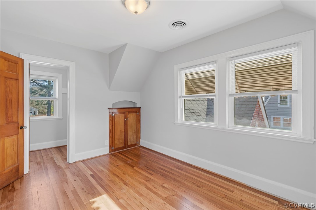 369 Main Street Reedville, VA 22539 - Photo 27 of 44 an empty room with wooden floor and windows