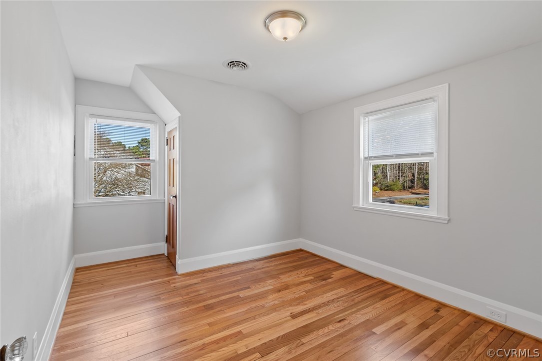 369 Main Street Reedville, VA 22539 - Photo 28 of 44 a view of an empty room with wooden floor and a window
