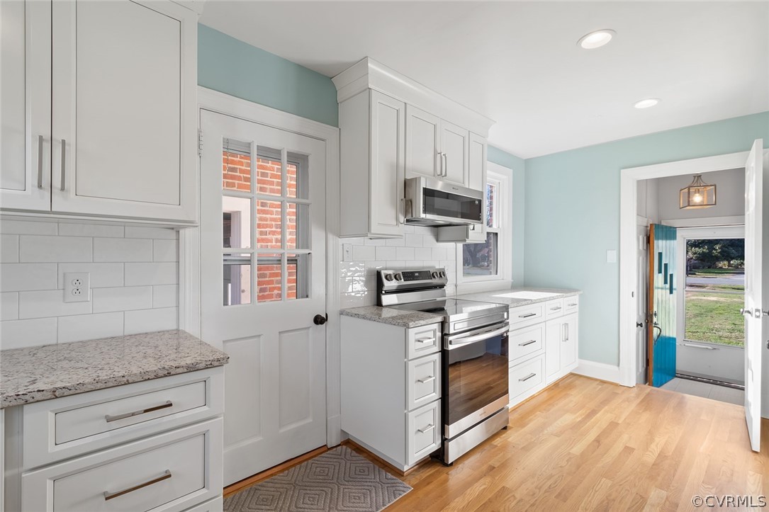 369 Main Street Reedville, VA 22539 - Photo 3 of 44 a kitchen with stainless steel appliances granite countertop a stove a sink and a refrigerator