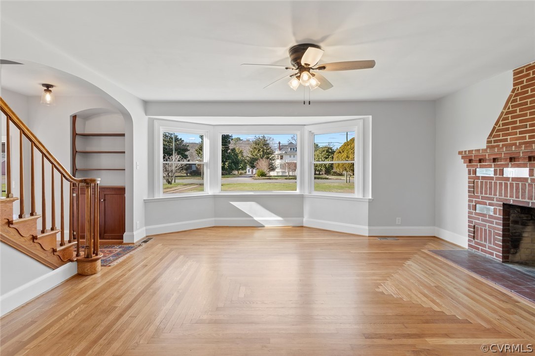 369 Main Street Reedville, VA 22539 - Photo 7 of 44 a view of an empty room with wooden floor fireplace and a window