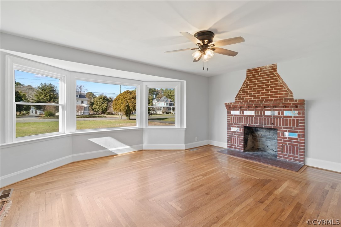 369 Main Street Reedville, VA 22539 - Photo 10 of 44 a view of an empty room with a fireplace and a window