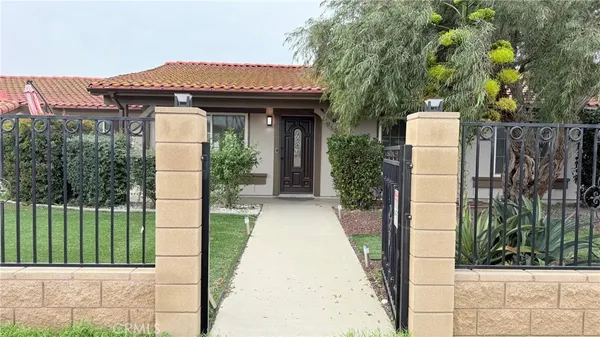 a view of a house with a small yard and plants