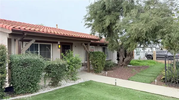 a view of a house with garden and plants