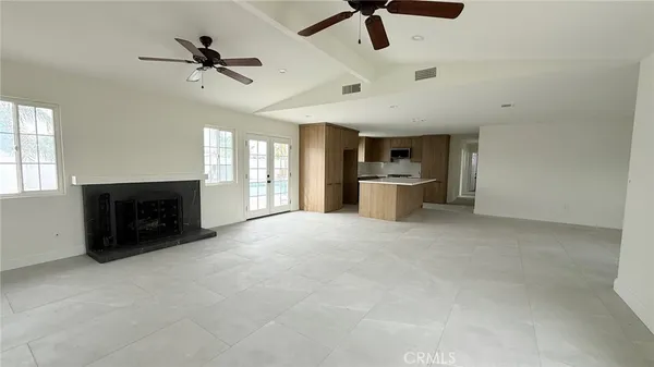 a view of a big room with windows and fireplace