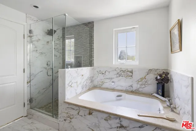 a bath tub sitting next to a shower