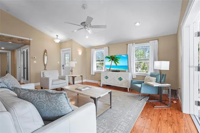 a kitchen with white cabinets and wooden floors