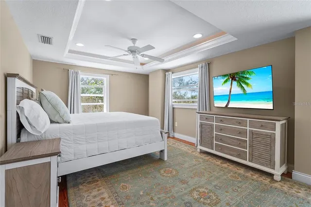 a bedroom with a bed and a painting on the wall