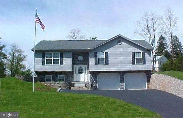 754 Siddonsburg Road Lewisberry, PA 17339 - Photo 1 of 1 a front view of a house with a garden and sitting area