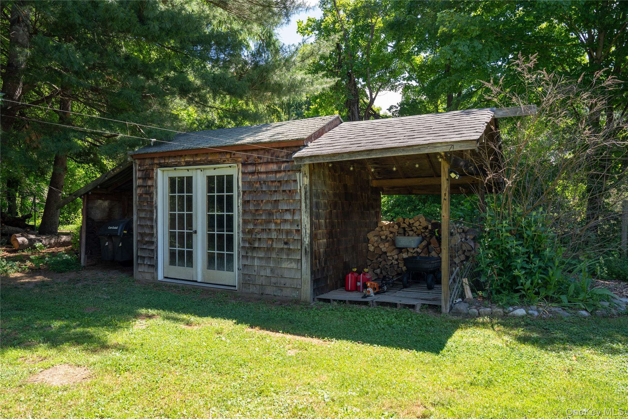 46 Schoonmaker Lane Stone Ridge, NY 12484 - Photo 22 of 28 Garden shed featuring weathered wood shake siding.