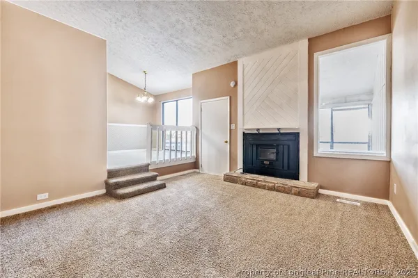 a view of a big room with windows and entryway