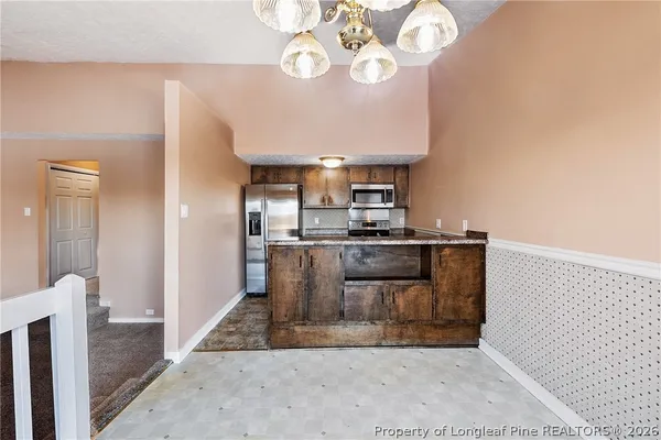 a kitchen with granite countertop a sink and a stove top oven