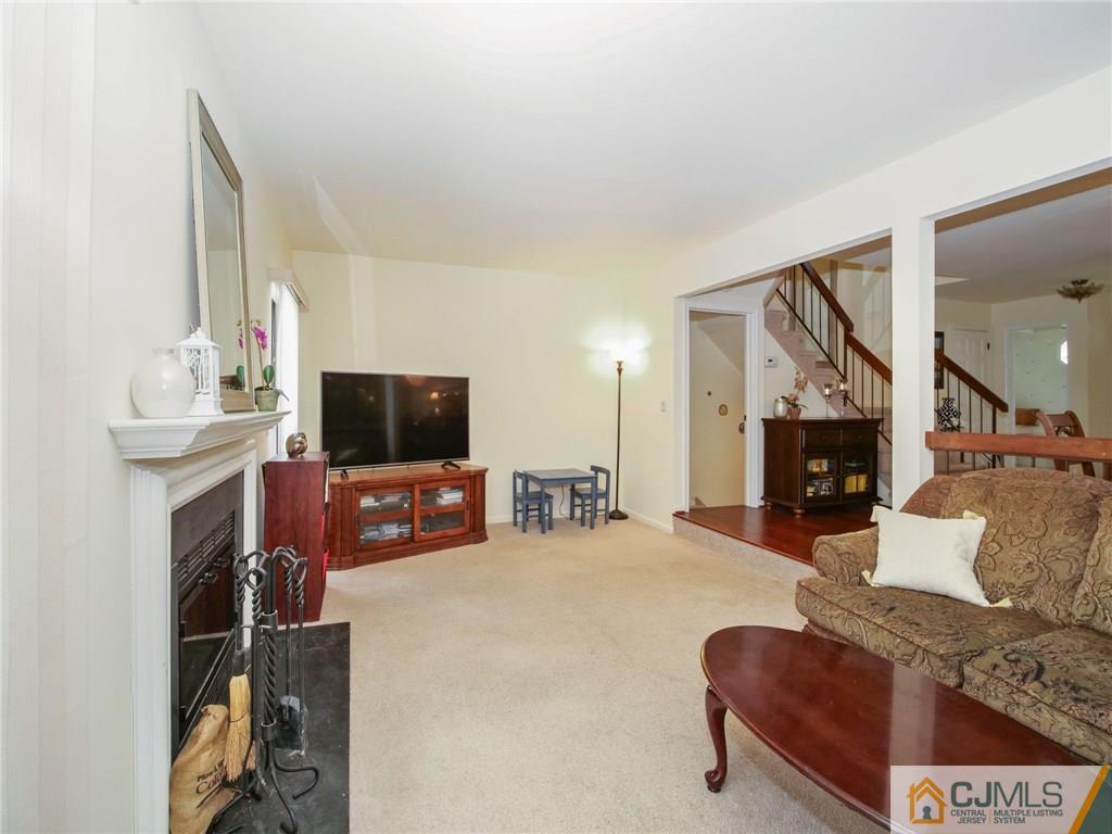 1402 Timber Oaks Road, Unit 1402 Edison, NJ 08820 - Photo 2 of 19 a living room with furniture and a flat screen tv