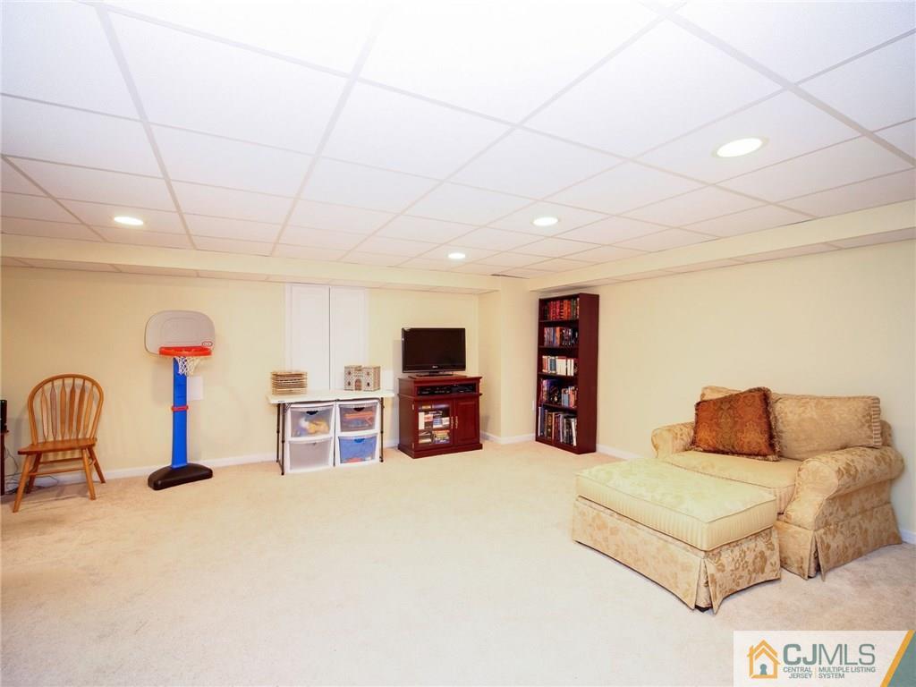 1402 Timber Oaks Road, Unit 1402 Edison, NJ 08820 - Photo 12 of 19 a living room with furniture and a flat screen tv