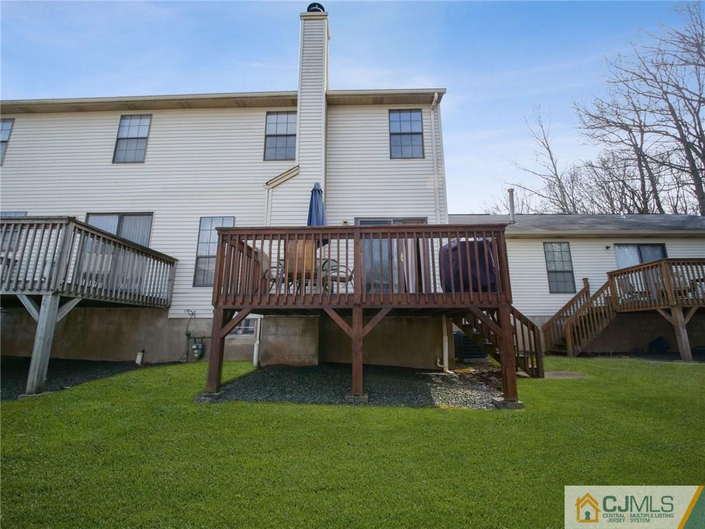 1402 Timber Oaks Road, Unit 1402 Edison, NJ 08820 - Photo 18 of 19 a view of backyard with a garden and deck