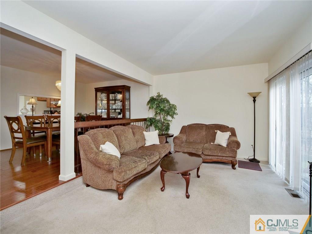 1402 Timber Oaks Road, Unit 1402 Edison, NJ 08820 - Photo 3 of 19 a living room with furniture and a lamp