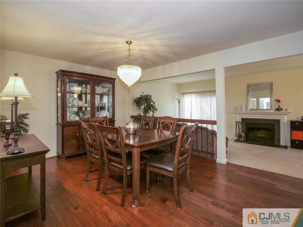 1402 Timber Oaks Road, Unit 1402 Edison, NJ 08820 - Photo 5 of 19 a view of a a dining room with furniture window and wooden floor